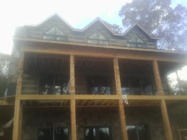 Dormers and porch framing on a large log home under construction — Roof Coating work by our crew in West Wardsboro
