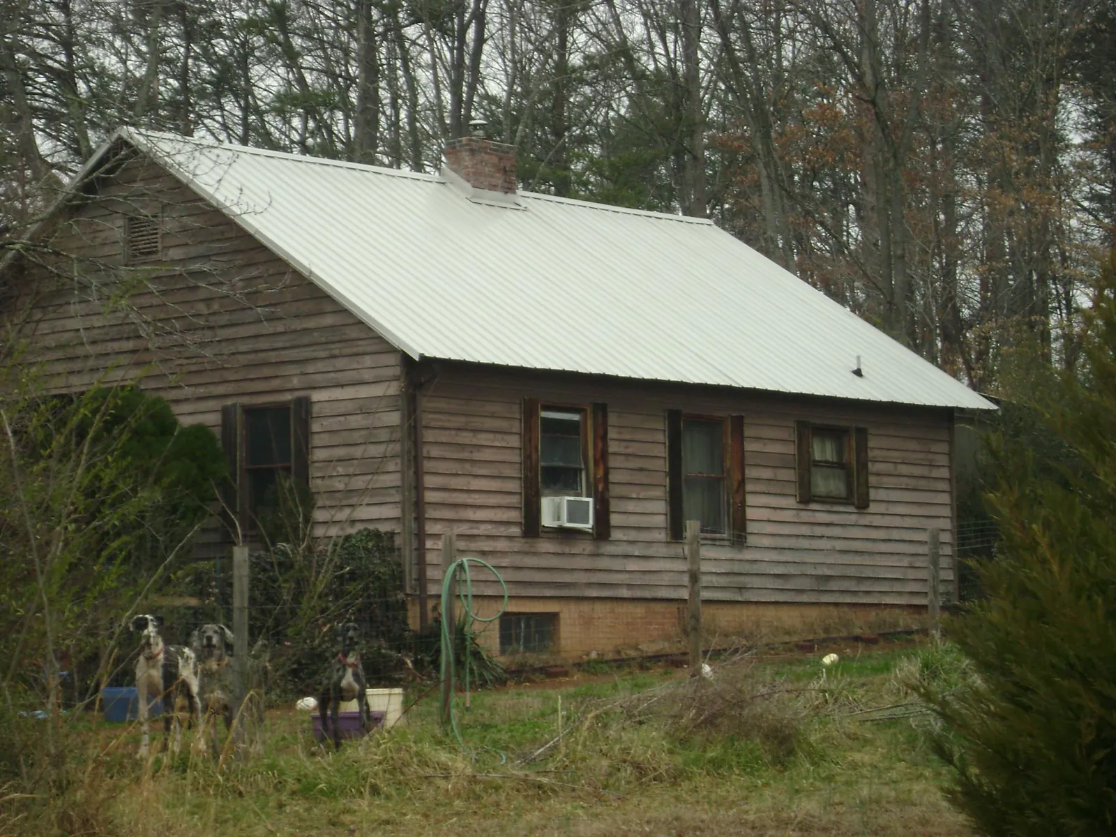 White metal roof on an old wood sided farmhouse, from a Metal Roof Installation job in West Wardsboro
